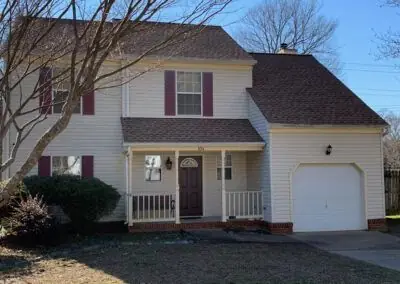 Two-storey vinyl-sided house with new shingles