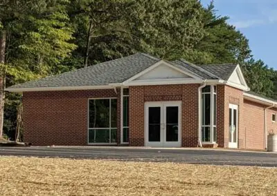 Brick commercial office building with a shingle roof