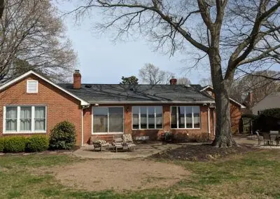 Brick ranch home with a dark roof