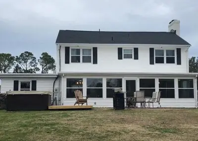 White two-storey home with a black shingle roof